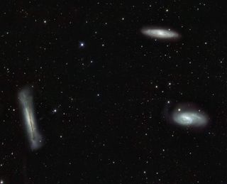 VST's view of the Leo Triplet shows the three galaxies in a roughly triangular configuration surrounded by a multitude of fainter objects: distant background galaxies and much closer Milky Way stars.