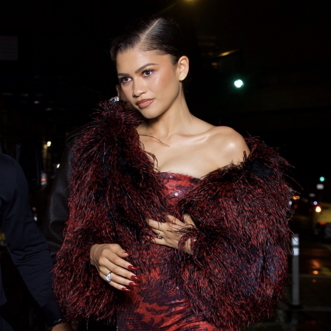 Zendaya exudes elegance as she swaps her white Met Gala-themed suit for a stunning red dress, complete with a feather boa and matching red heels, as she makes a glamorous entrance at the Met Gala after party in New York 05-05-2025