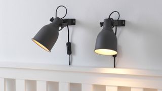 IKEA HEKTAR Wall / Clamp Spotlights attached to wall above bed