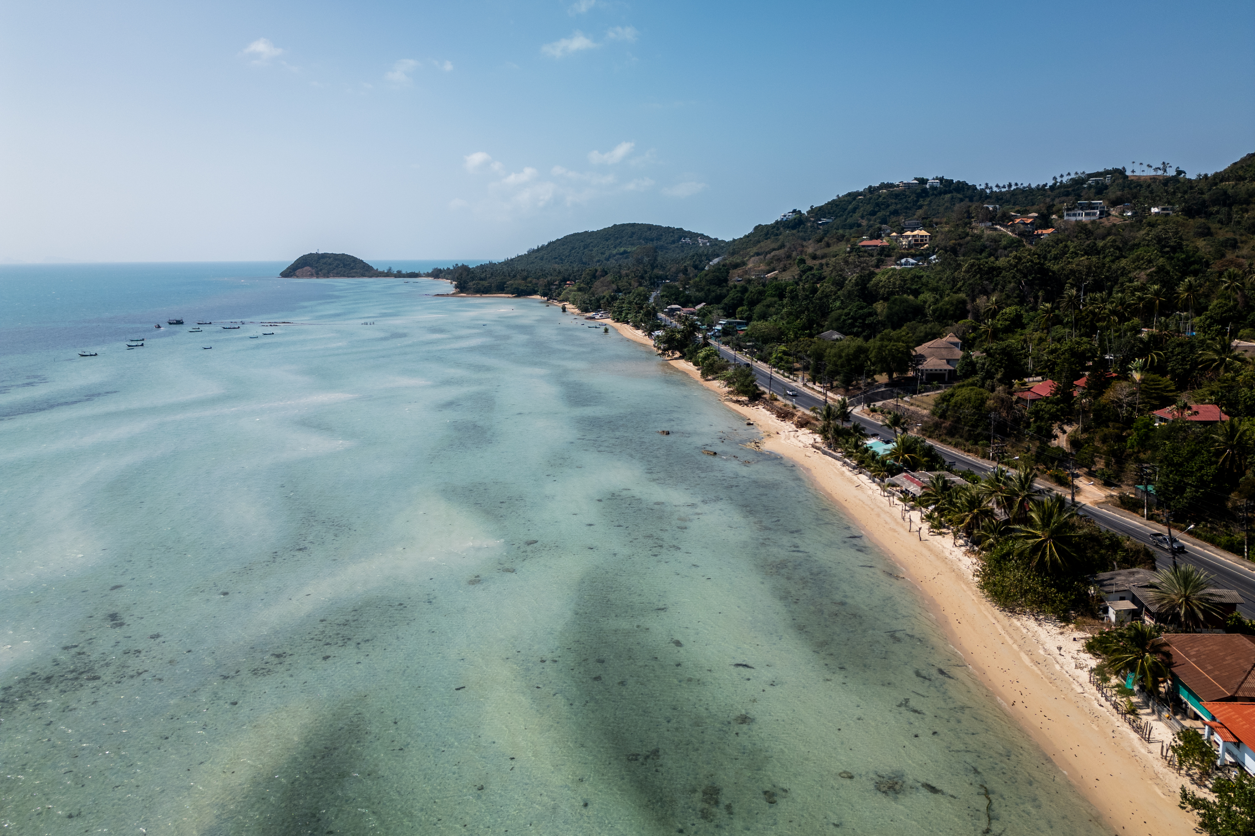 A photo of Bang Makham Beach, with blue seas and golden sands, close to The Four Seasons Resort in Koh Samui, Thailand