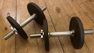 Domyos Weight Training 20 Kg Threaded Weights Kit on hard floor