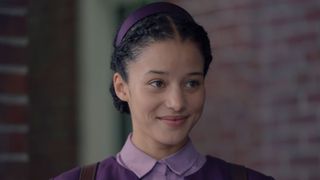 Agnes looks at something offscreen