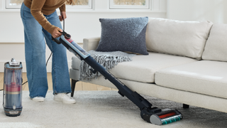 Shark PowerDetect Transformer being used as a stick vacuum in a neutrally decorated room