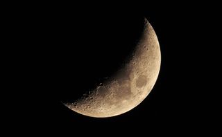 A close up of the moon showing craters