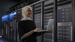 A person in a data center using a Dell laptop