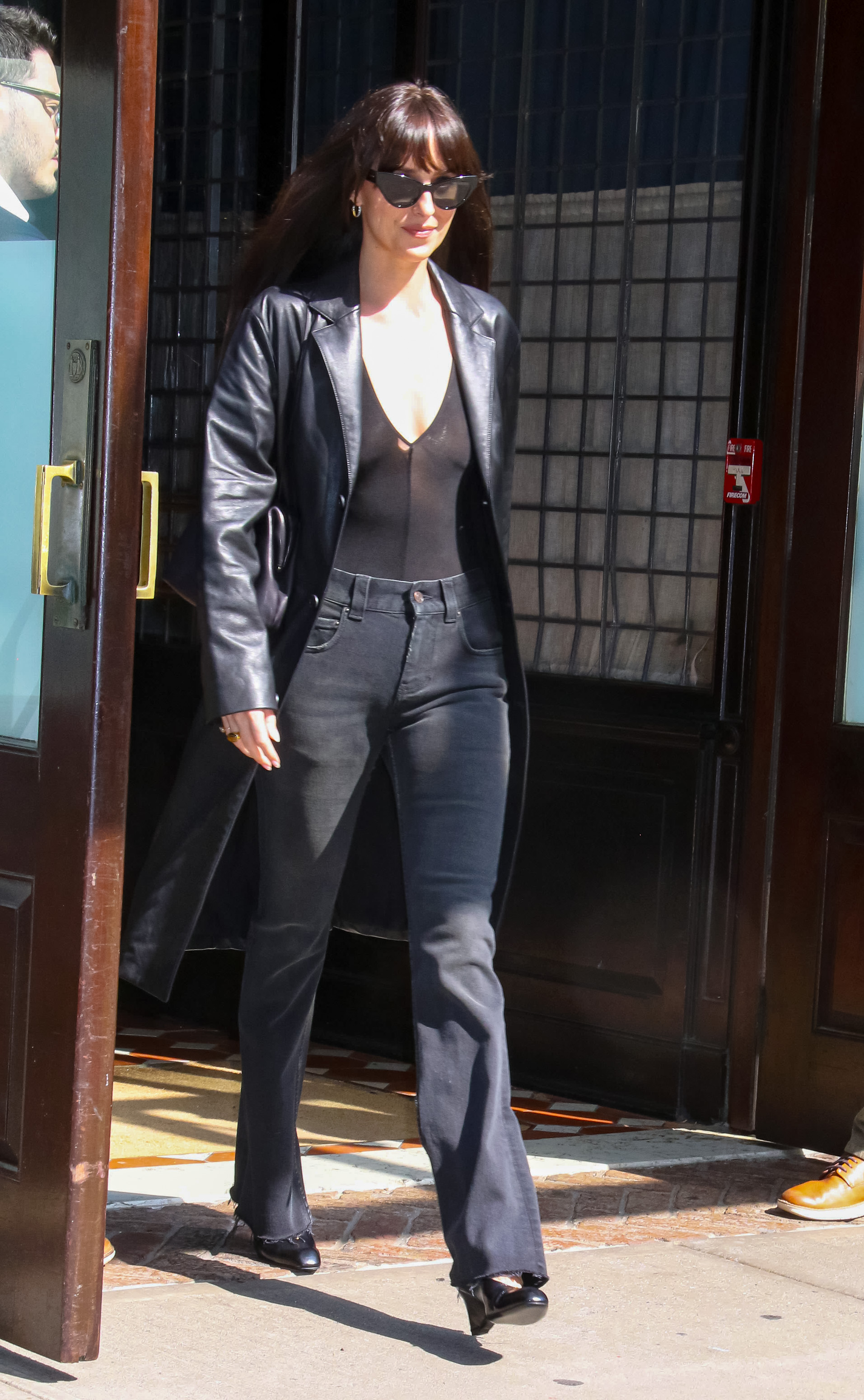 Dakota Johnson wears black wedges from Khaite in NYC.