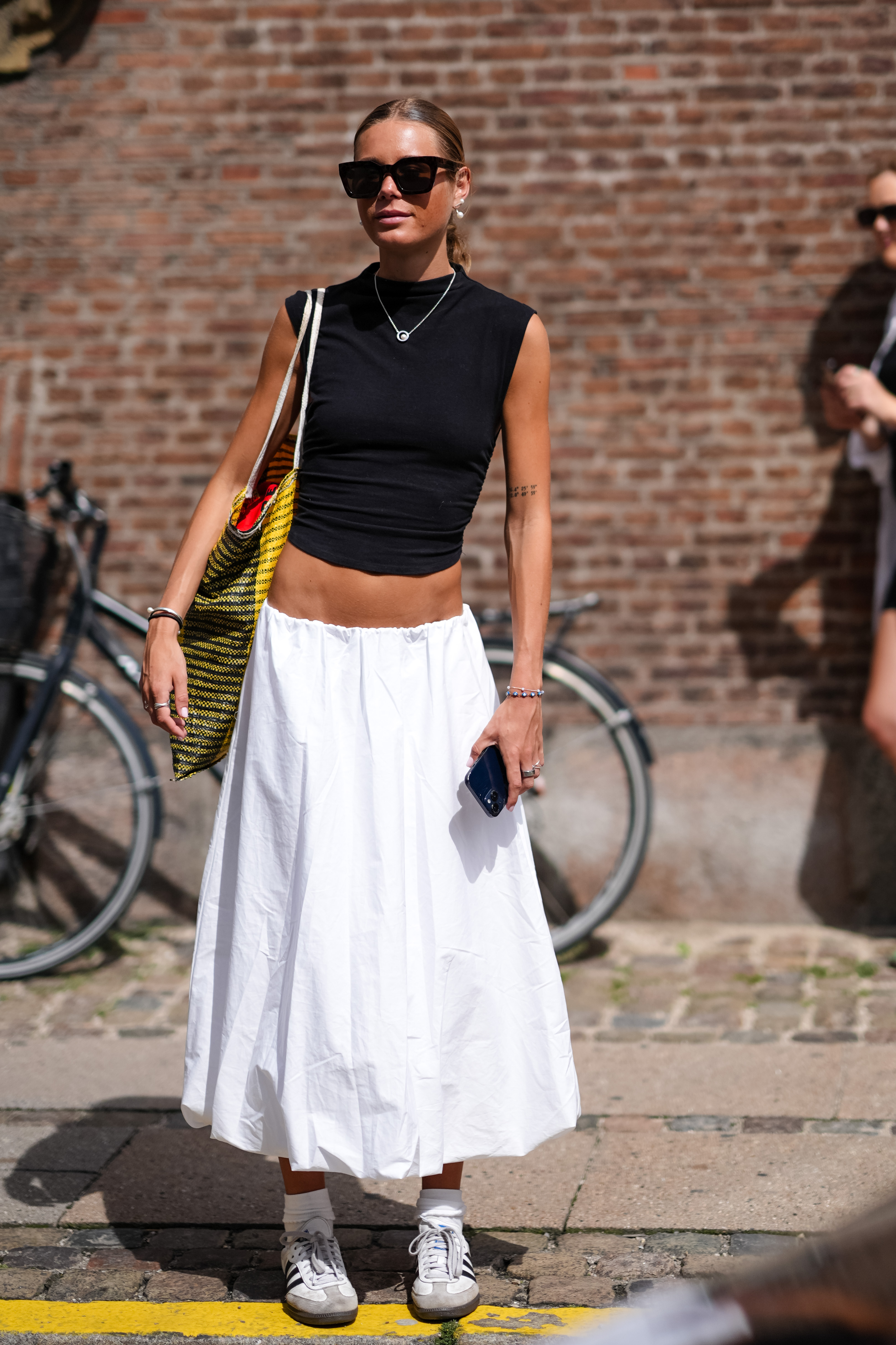 woman wearing black top and white skirt