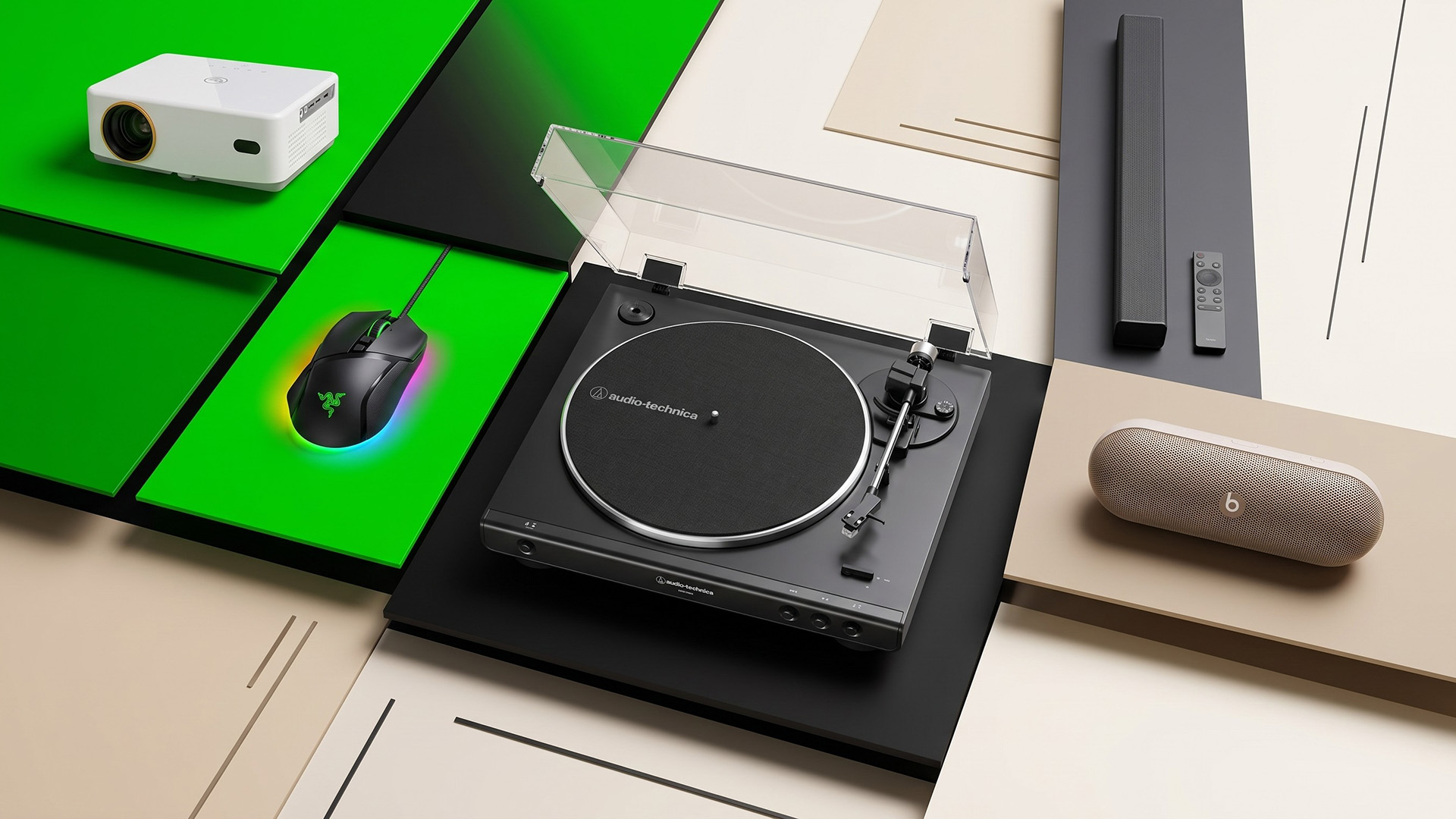 A turntable, mouse, projector, soundbar, and portable speaker.