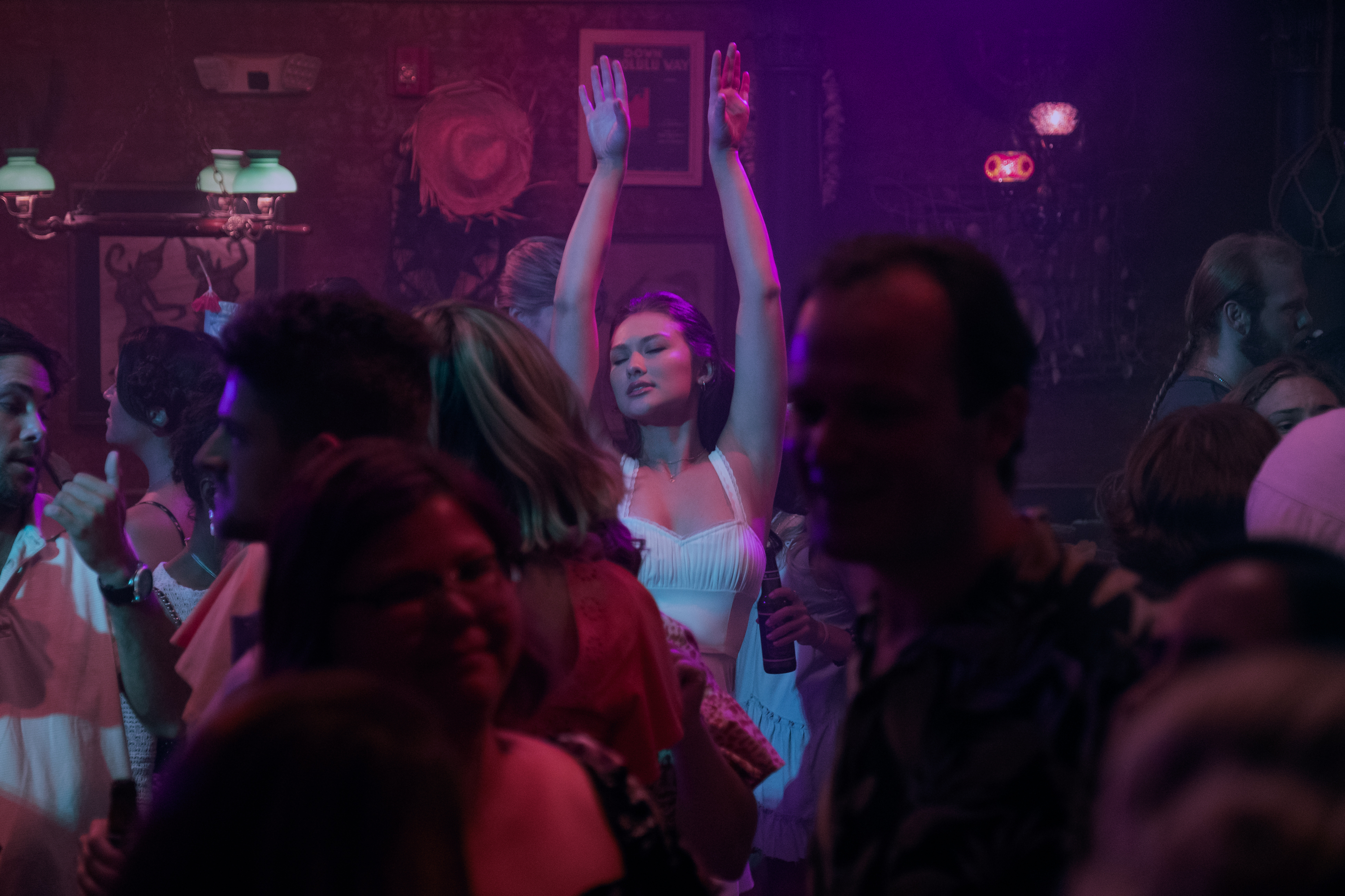 belly wears a white dress and throws her arms up dancing in the summer i turned pretty