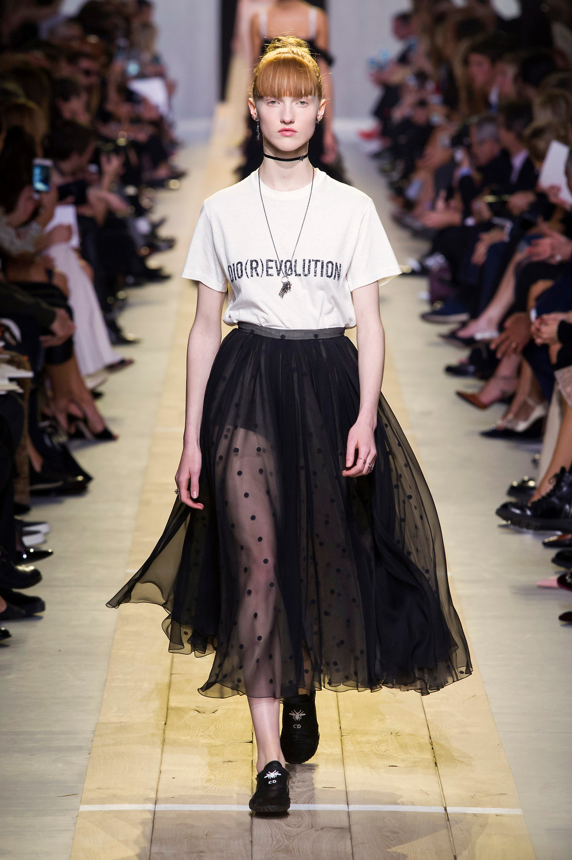 a model from Dior wearing a diorrevolution shirt