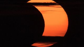 A partial solar eclipse is seen from Arlington, Virginia on June 10, 2021.