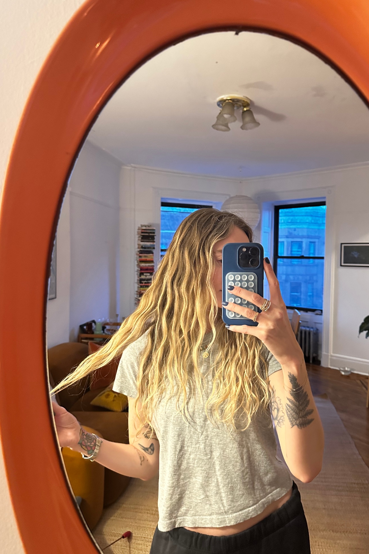 Hannah Baxter takes a selfie in an orange mirror.