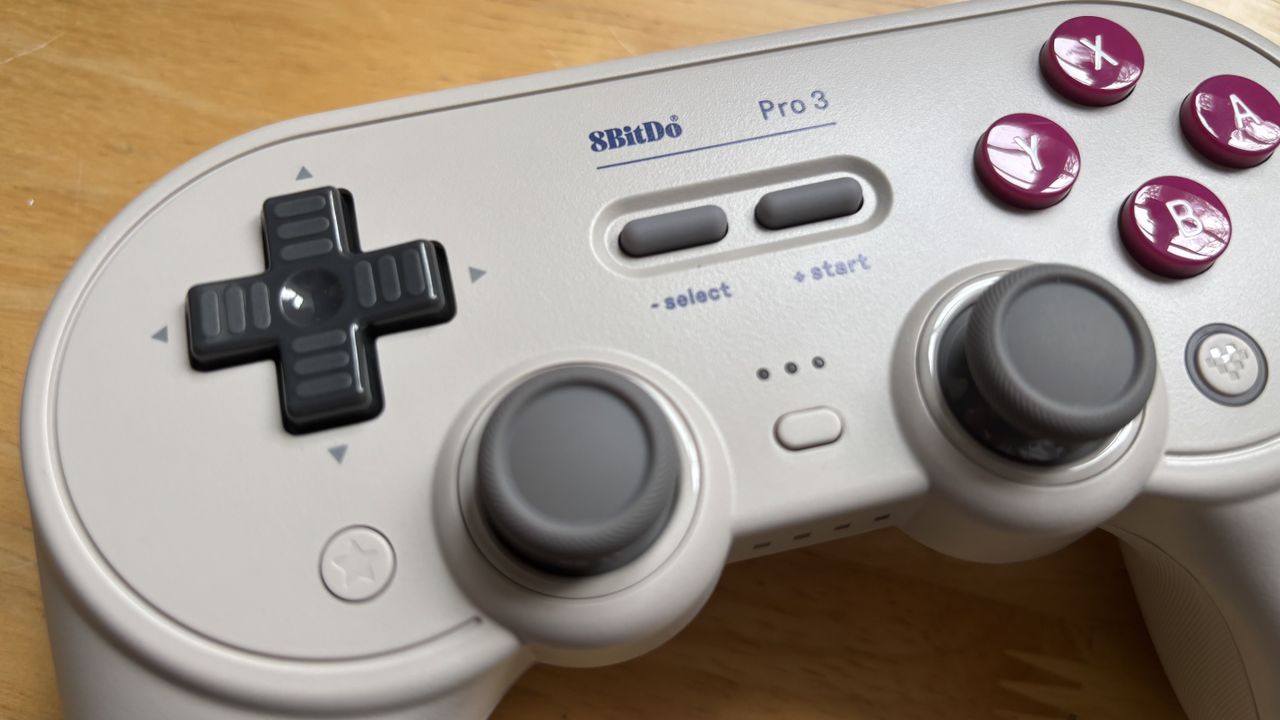 The 8BitDo Pro 3 controller photographed on a wooden table.