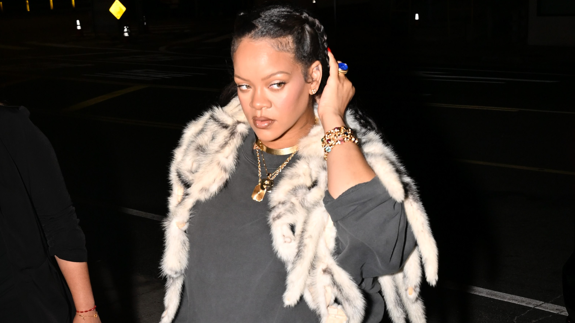 Rihanna signaled the early start of fall fashion with a fur shawl in LA