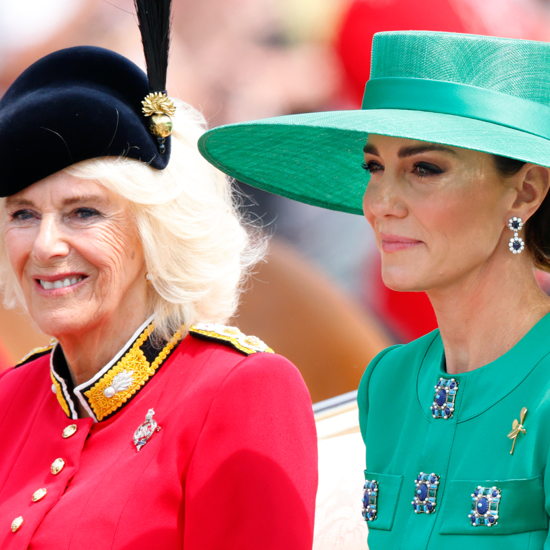 Queen Camilla wears a red uniform while Kate Middleton wears a green dress and matching hat