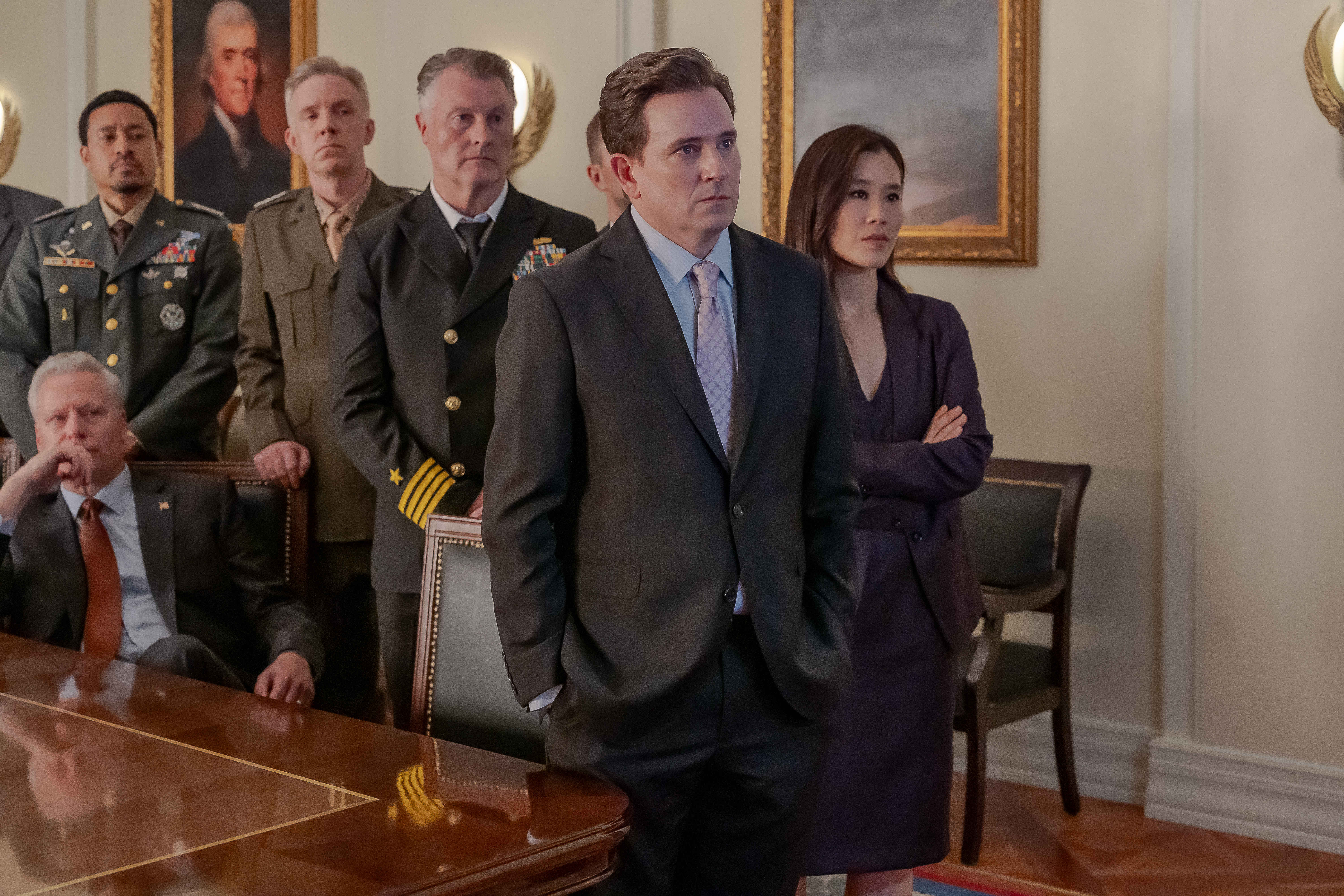 A group of people stand in a White House office, in 'Tempest.'