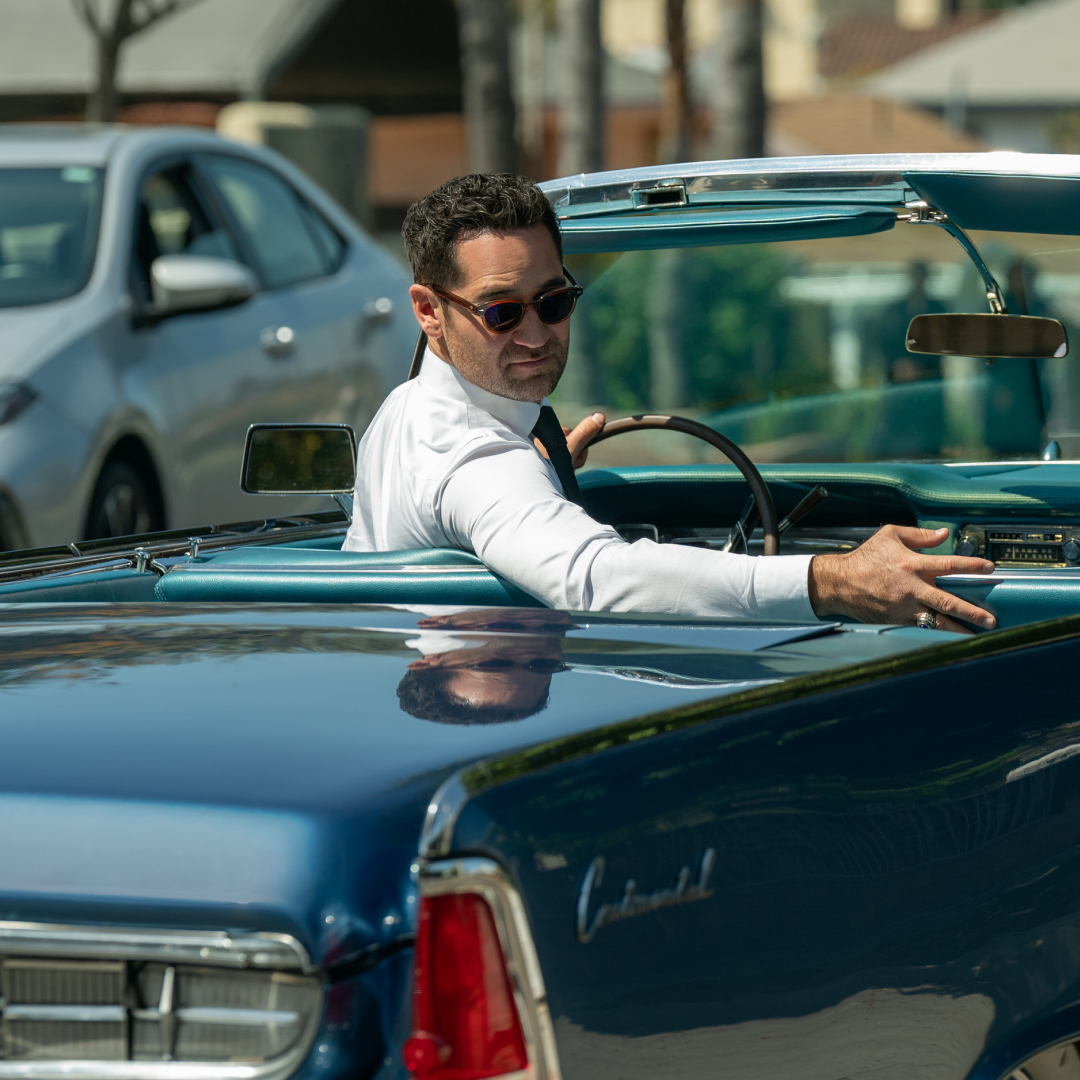 Manuel Garcia-Rulfo as Mickey Haller, looking back from the driver&#039;s seat of a convertible Lincoln, in episode 303 of The Lincoln Lawyer.