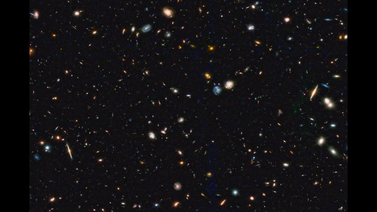 An image showing hundreds of galaxies in deep space.