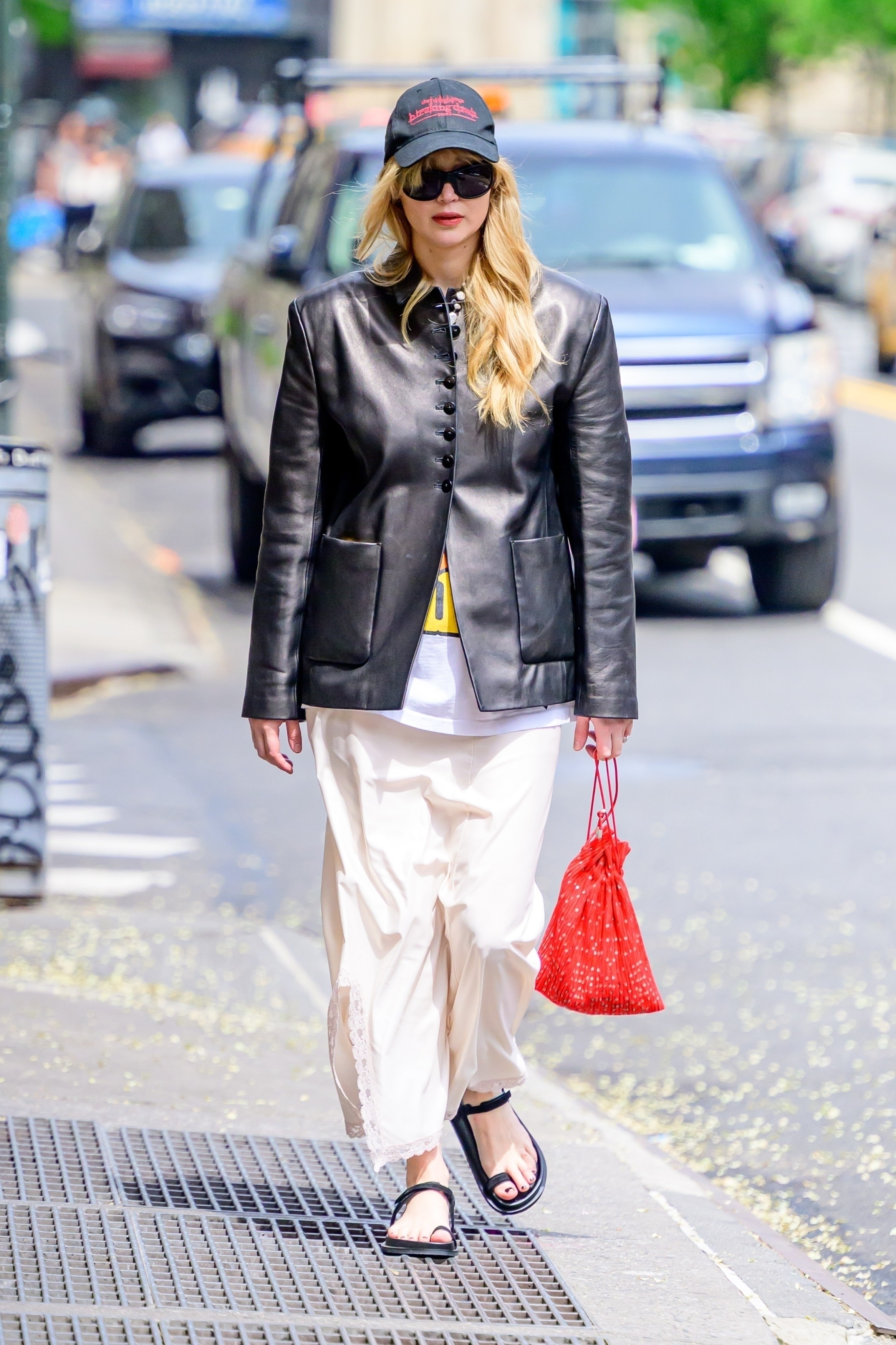 Jennifer Lawrence wears St. Agni toe-ring sandals in May 2025