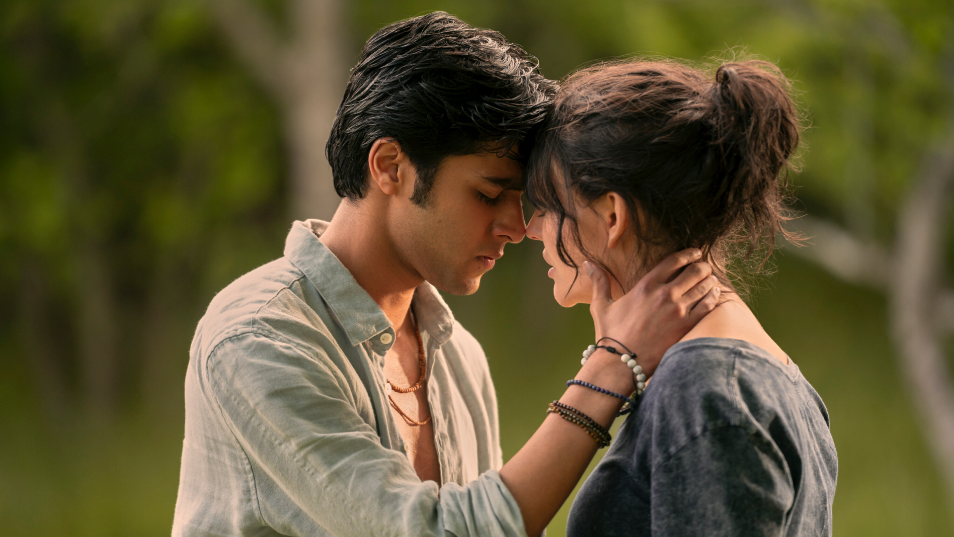 A teenage boy holds a teenage girl&#039;s neck as they almost kiss, in &#039;We Were Liars.&#039;