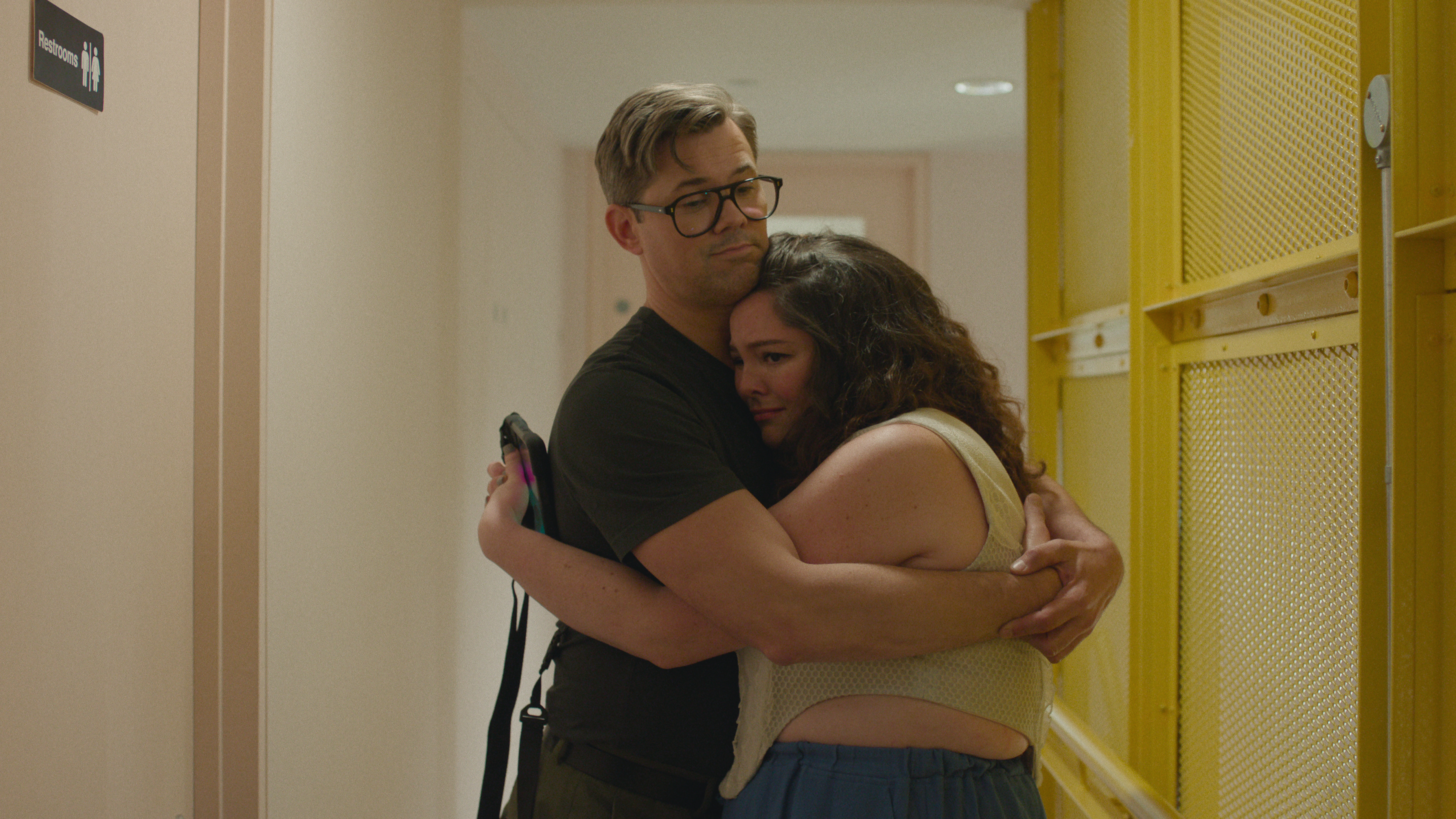 andrew rannells hugging meg stalter in a still from too much