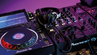 A pair of DJ headphones sat on a mixer