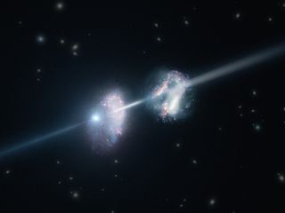 This artist's impression shows two galaxies in the early universe. The brilliant explosion on the left is a gamma-ray burst. The light from the burst travels through both galaxies on its way to Earth (outside the frame to the right).