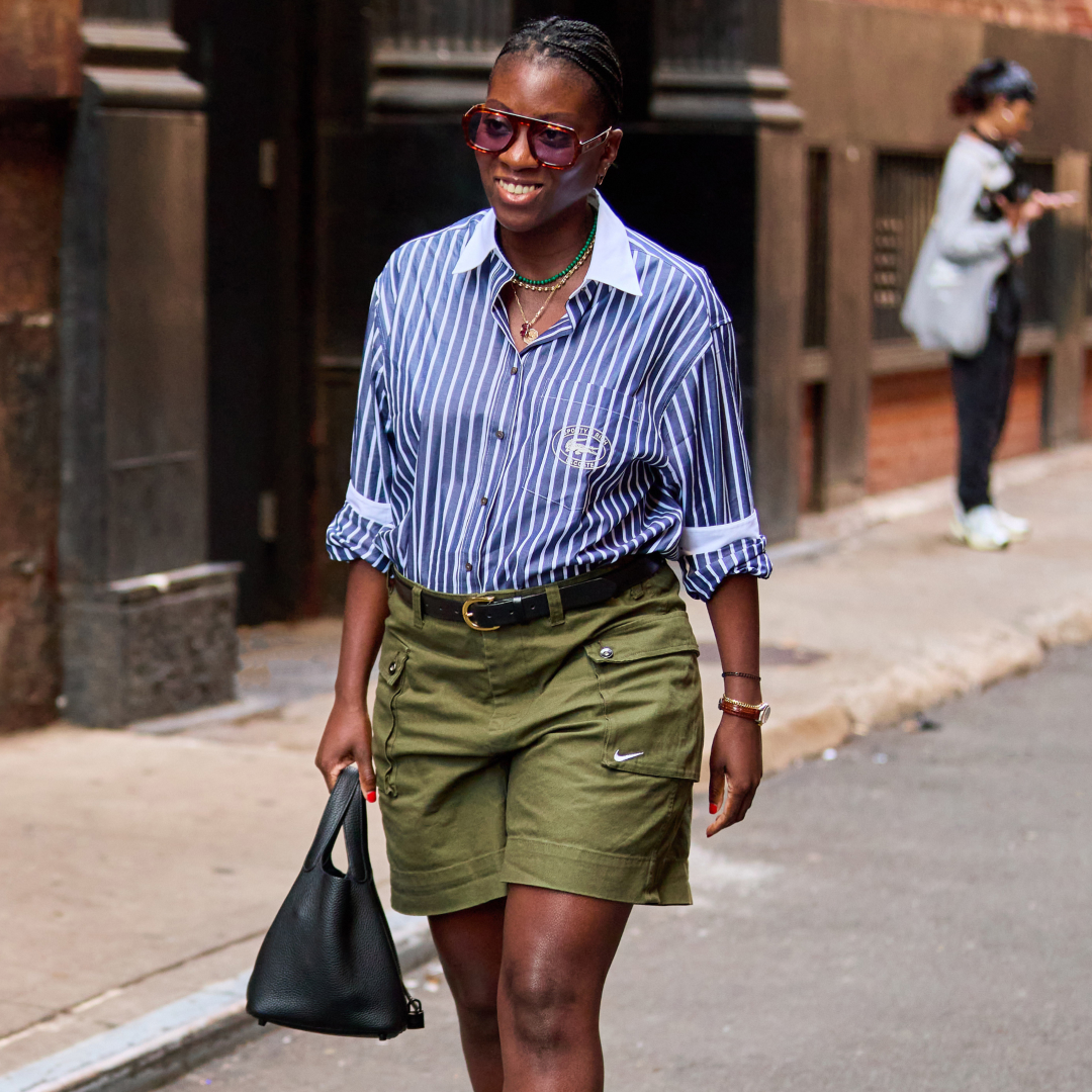 Nikki ogunnaike wearing striped shirt and green shorts 