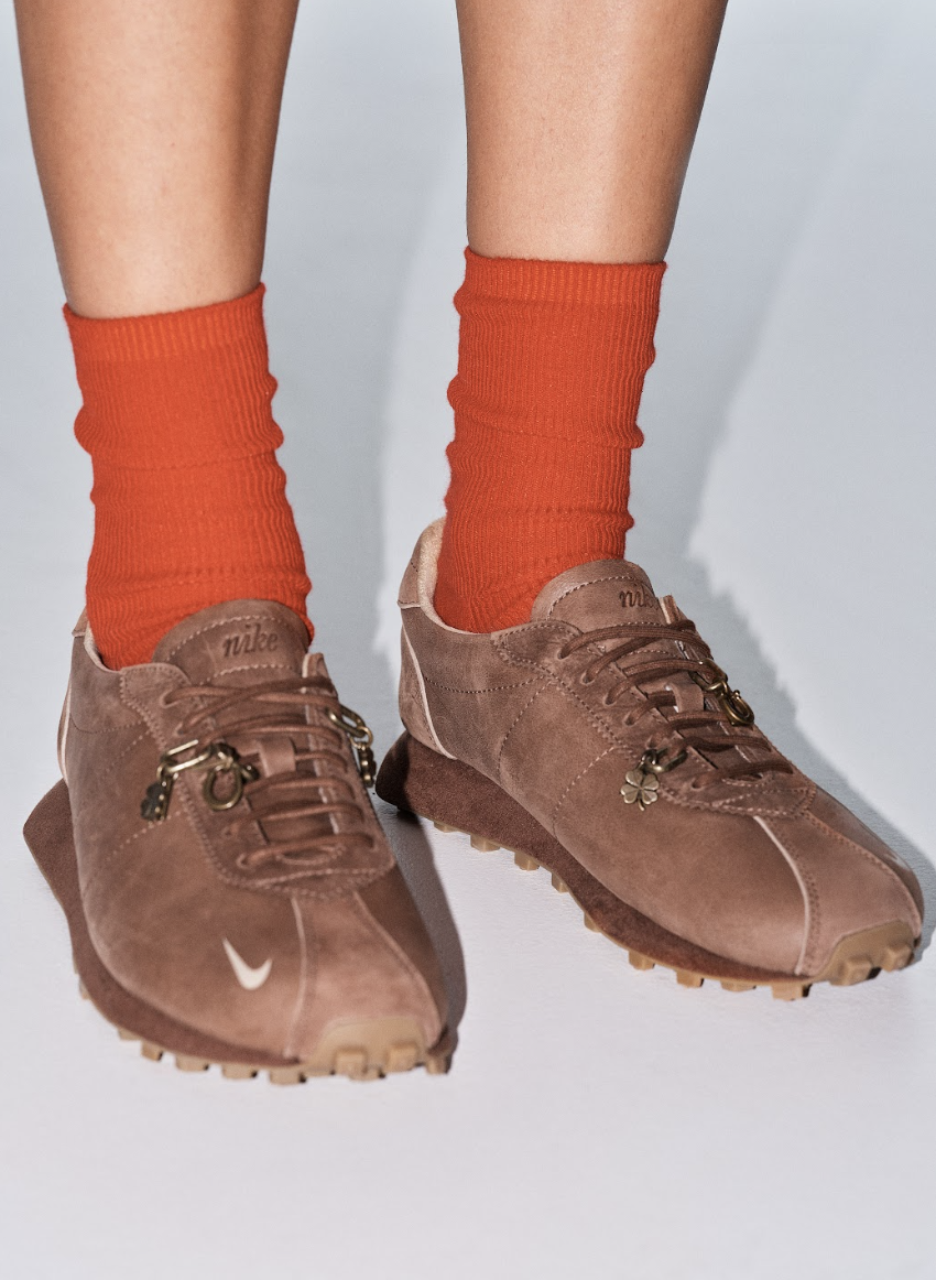 a pair of Nike sneakers by Aritzia worn with red socks