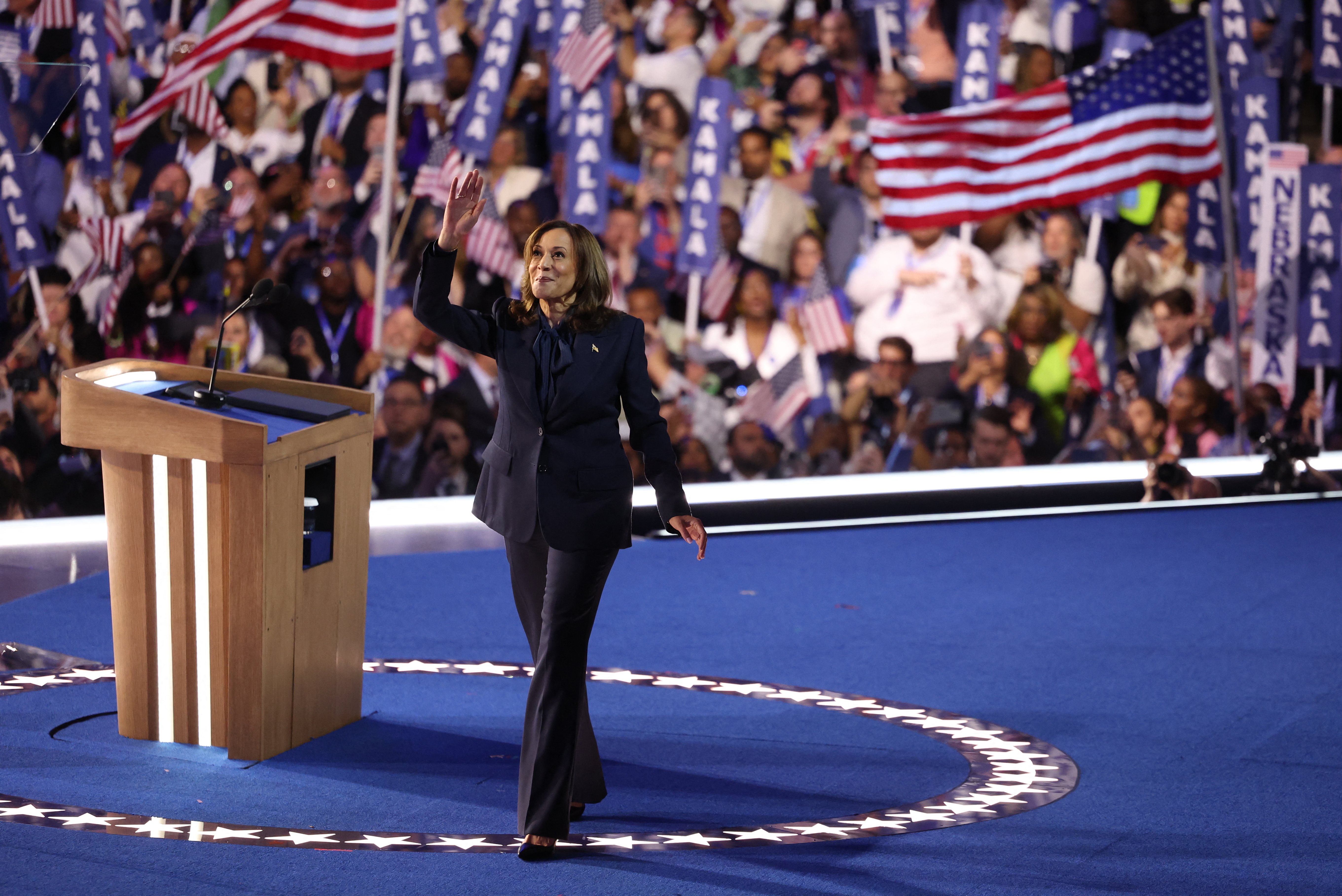 US Vice President and 2024 Democratic presidential candidate Kamala Harris waves as she leaves the stage on the fourth and last day of the Democratic National Convention (DNC) at the United Center in Chicago, Illinois, on August 22, 2024. Vice President Kamala Harris formally accepted the party's nomination for president today at the DNC which ran from August 19-22 in Chicago.
