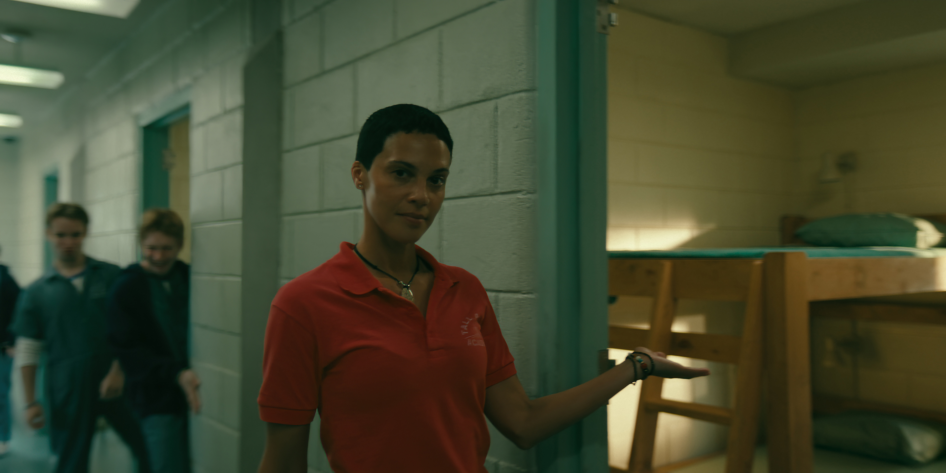 Tattiawna Jones as Rabbit wearing a red polo touring the dorms in wayward