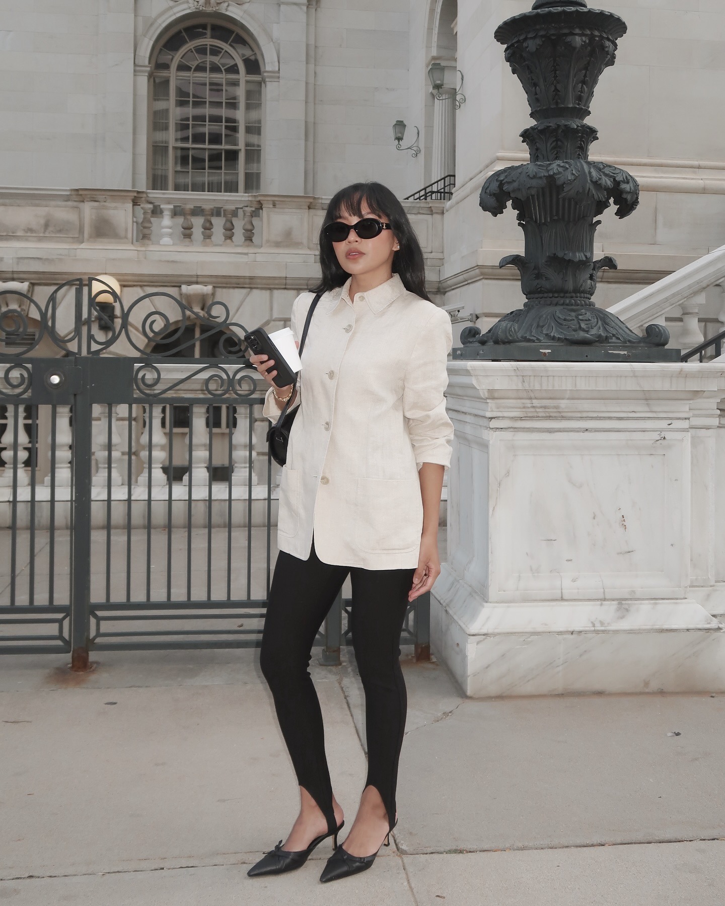 Fashion person Dawn Tan wears a winter legging trend. She wears a cream blazer, stirrup leggings and black bow kitten heels. This image was recently taken from her Instagram.