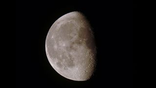 The moon in close-up, partially illuminated.