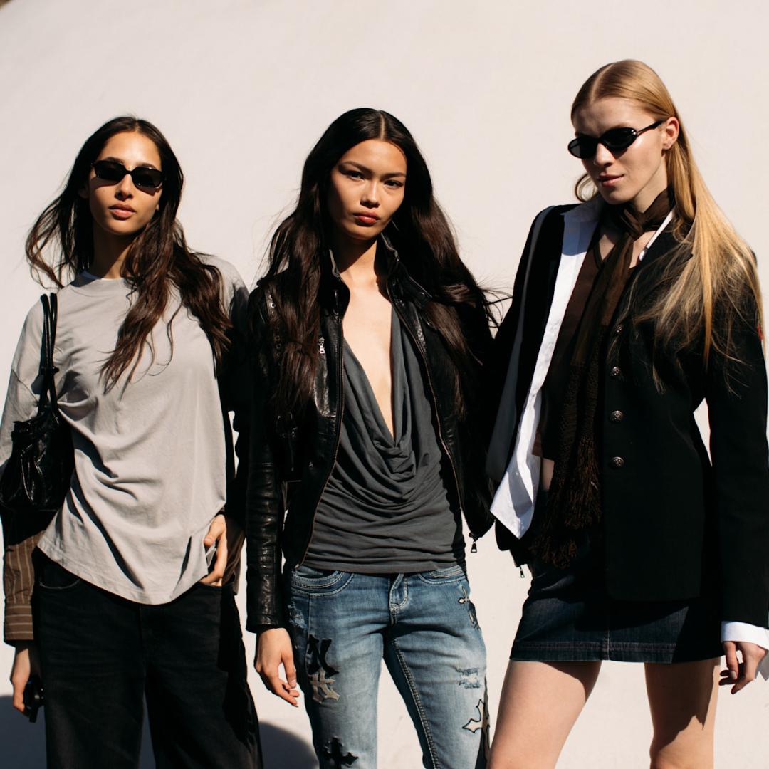 Attendees at paris fashion week fall 2025 standing in front of beige wall