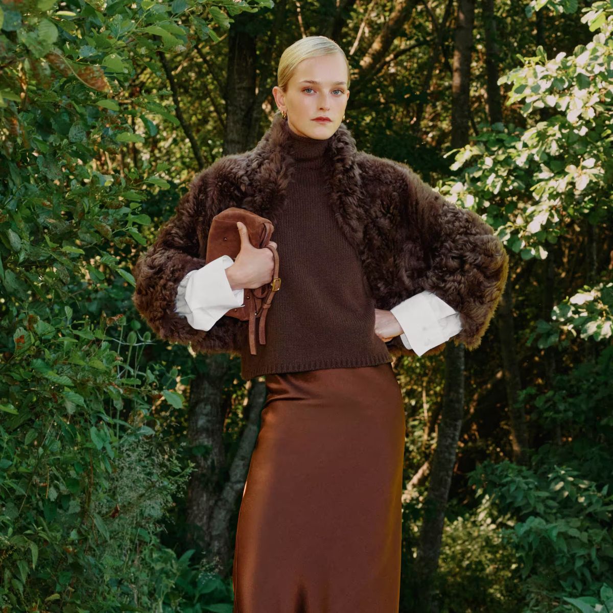 model wearing me+em fur coat, brown jumper and satin caramel skirt