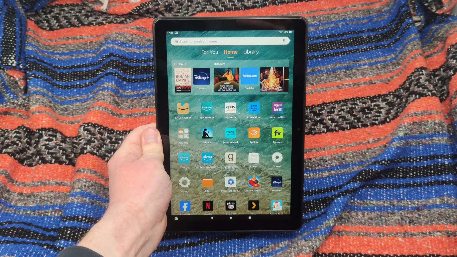 The Amazon Fire HD 10 (2023) on a colored background.