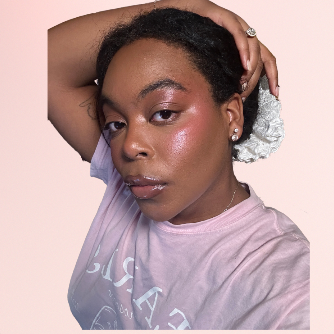 An image of Ariel Baker wearing blush and surrounded by blush makeup products