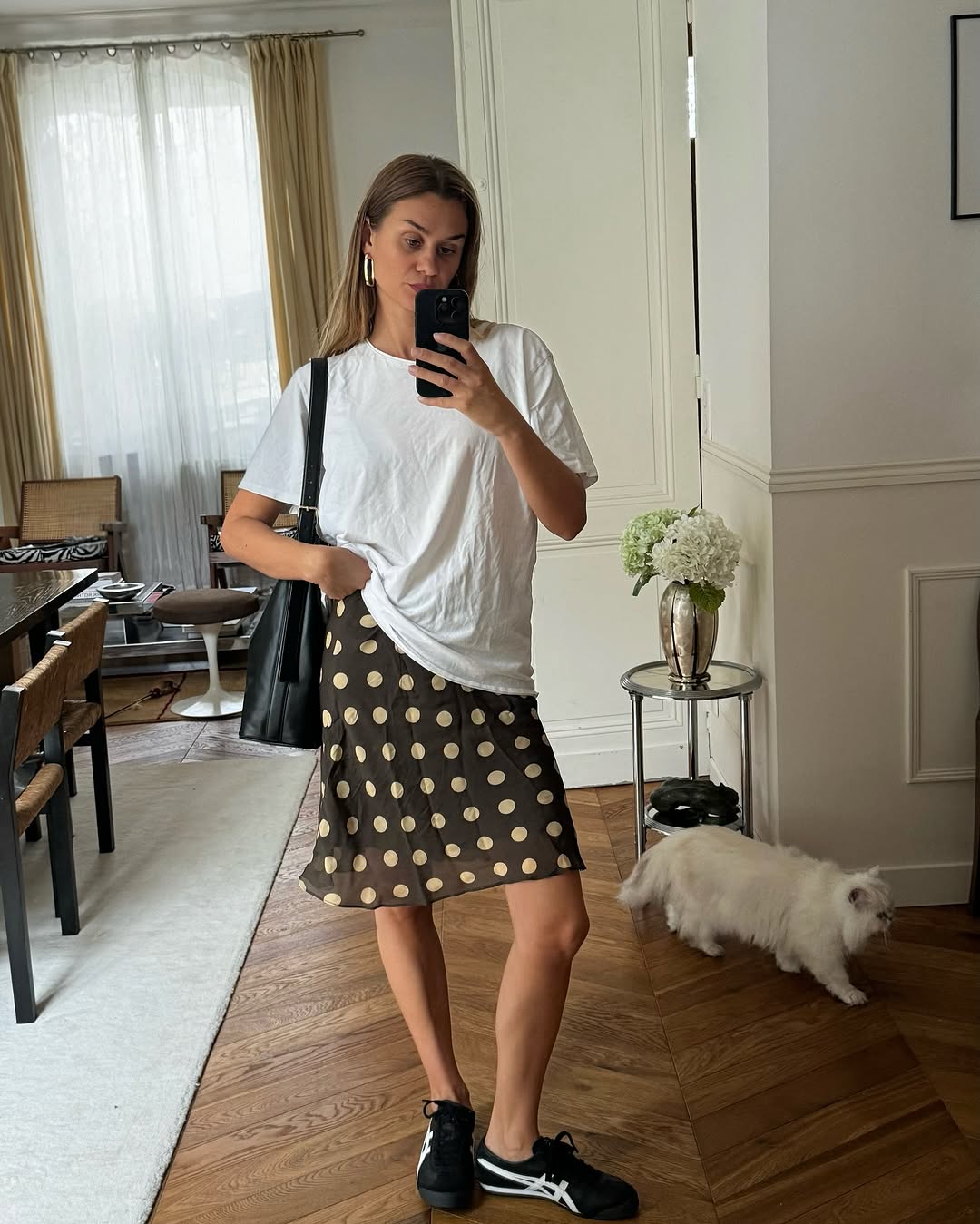 Woman wearing a polka dot skirt.