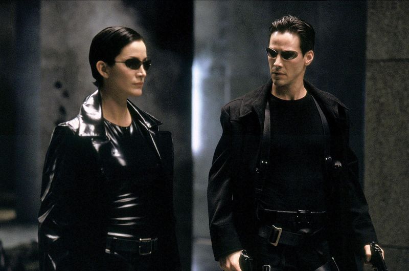 carrie anne moss and keanu reeves in the matrix wearing leather trench coats