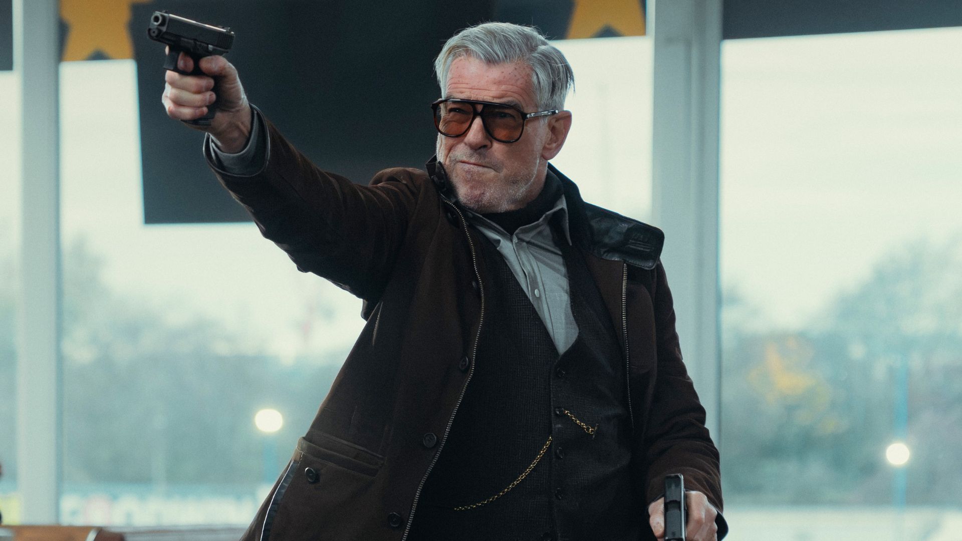Conrad points a gun at something offscreen