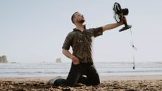 Man on beach with fan Dziana Hasanbekava | Pexels