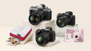 A selection of cameras on a cream background.