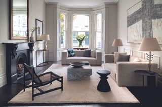 Long white living room with bay windows