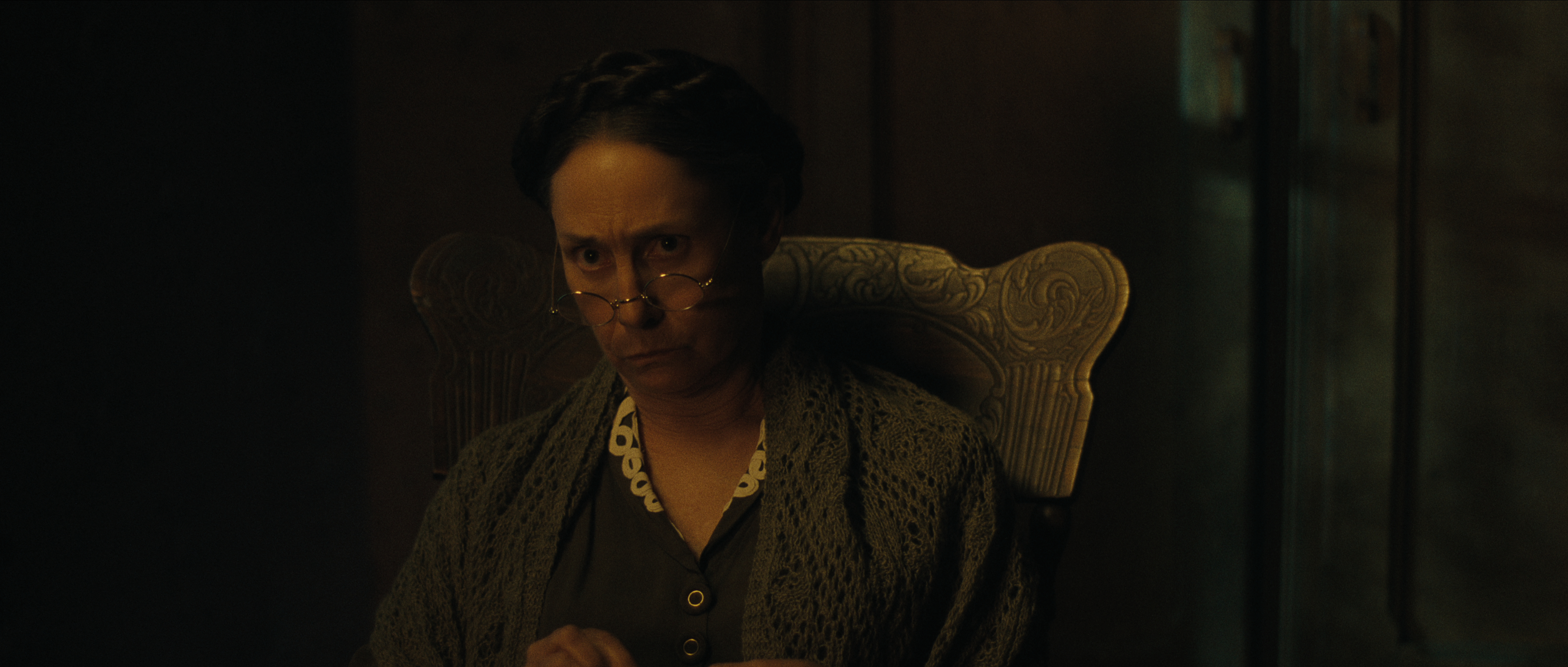 laurie metcalf as augusta Gein wearing glasses and a sweater in monster the ed gein story