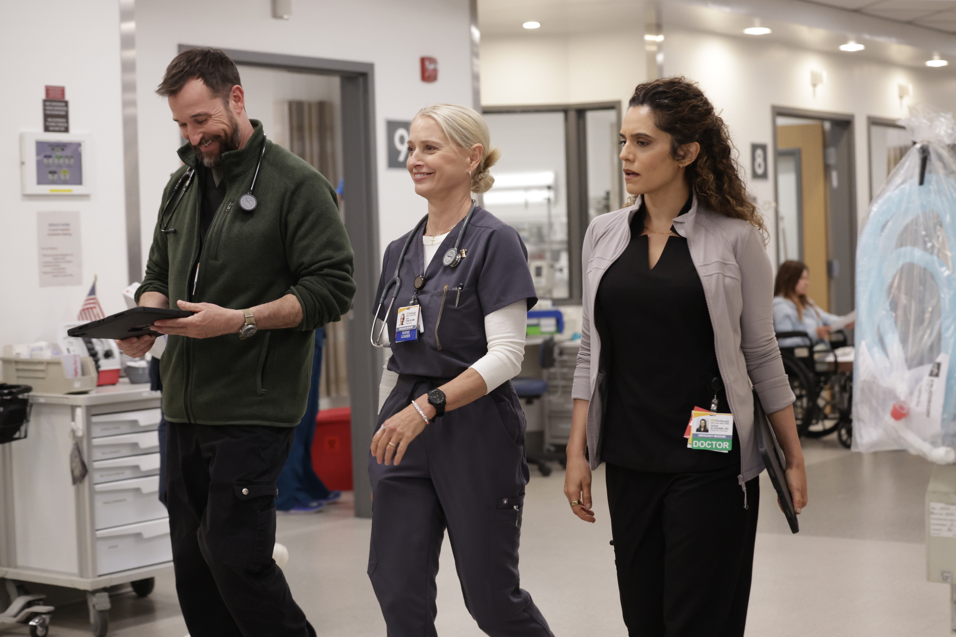 Noah Wyle, Katherine LaNasa, Sepideh Moafi as doctors walking through the hospital in the pitt season 2