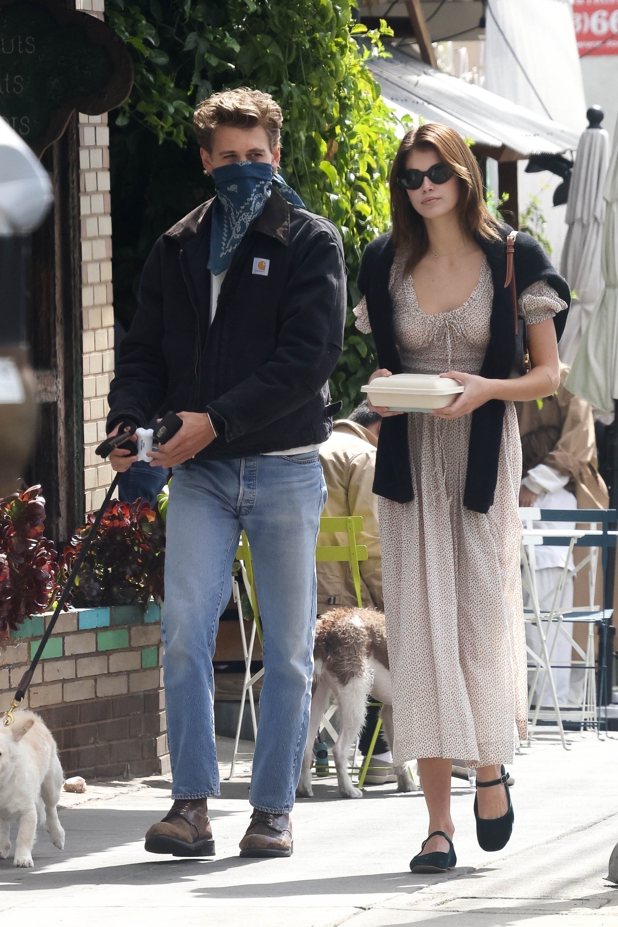 Kaia Gerber walking with Austin Butler while wearing a D&amp;ocirc;en dress and mary jane flats