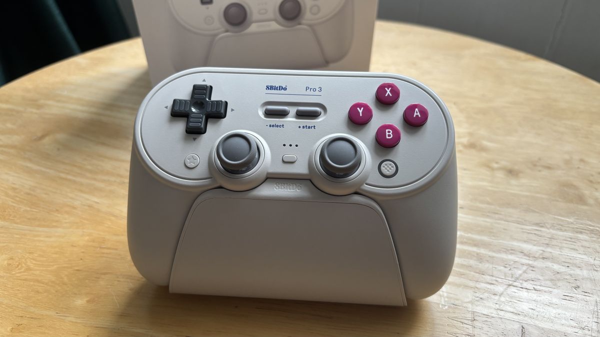 The 8BitDo Pro 3 controller photographed on a wooden table.