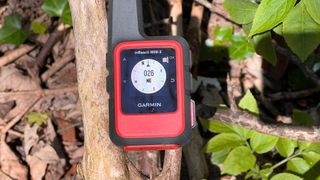 Garmin inReach Mini 2 hiking GPS in someone's hand