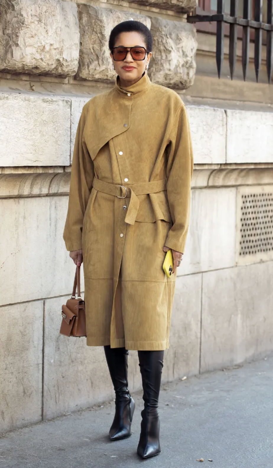 Woman wears brown suede dress and knee-high boots