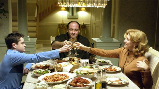 tony soprano at the head of a dinner table with his wife and son in the tv show the sopranos